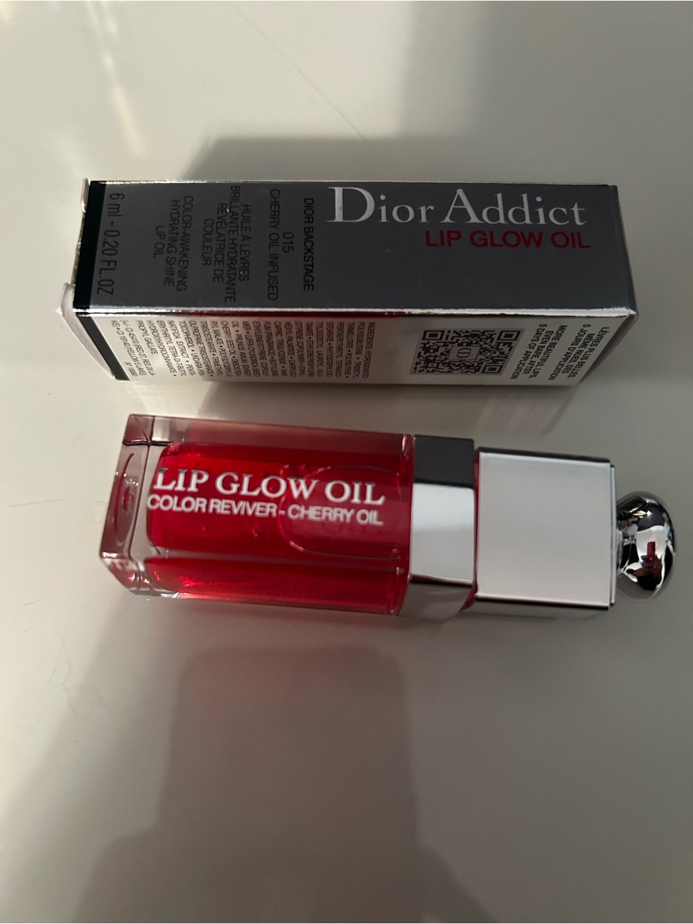 Dior lip glow oil in shade 015 Cherry.  Never used